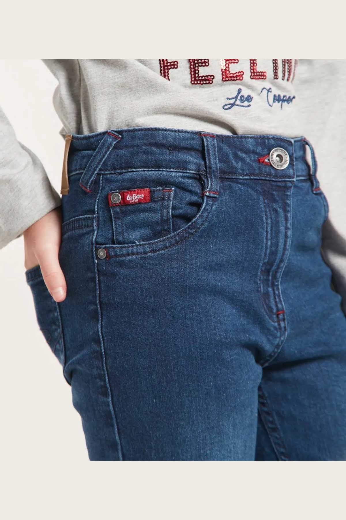 Kids blue denim jeans close-up of waistband button and coin pocket patch