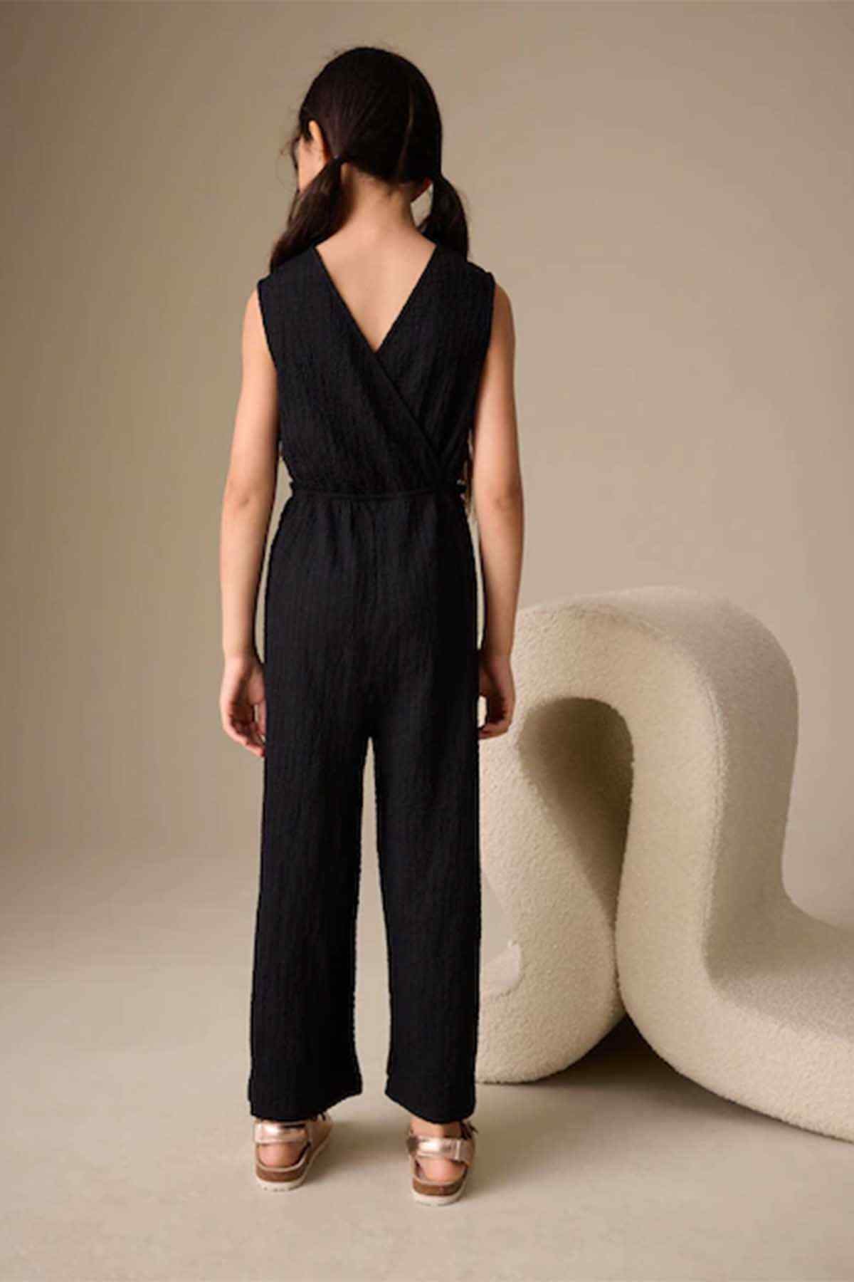 Kids black sleeveless jumpsuit with tie waist and V-back design
