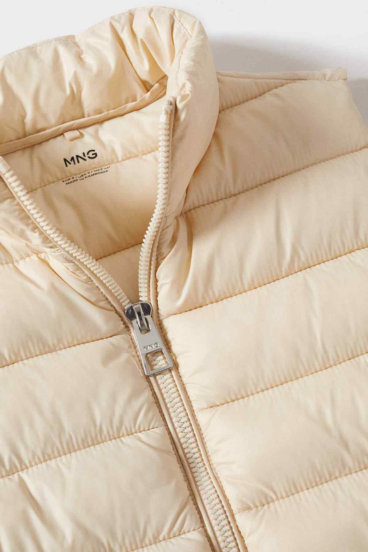 Ecru quilted puffer vest zip close-up with MNG tag and metal slider