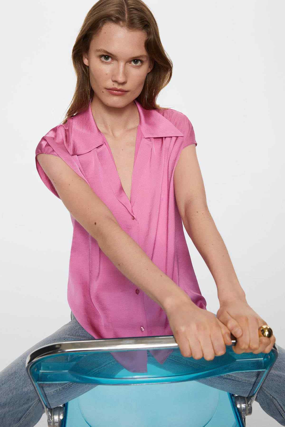 Pink short-sleeve button-up shirt with collar and chest button detail
