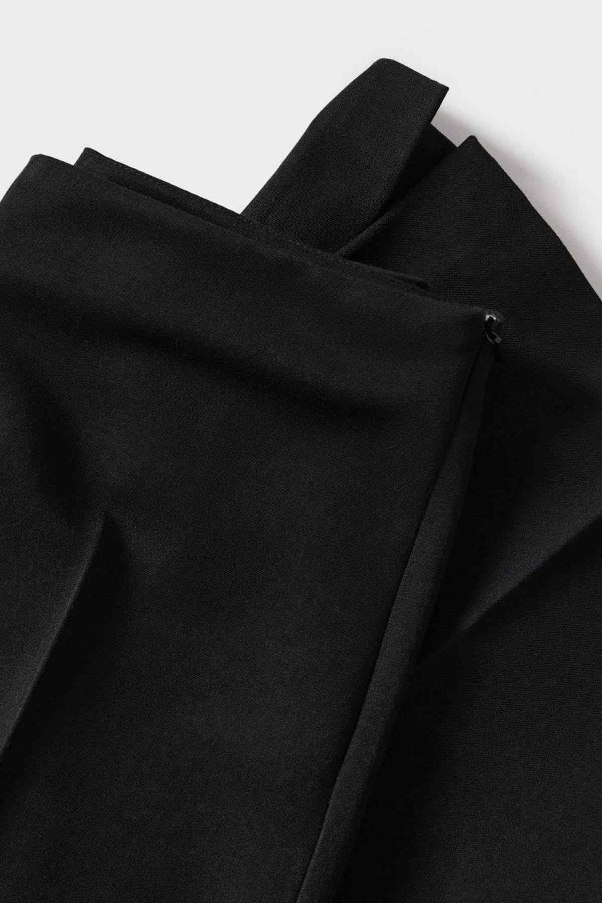 Black trousers fabric close-up with side seam and zipper