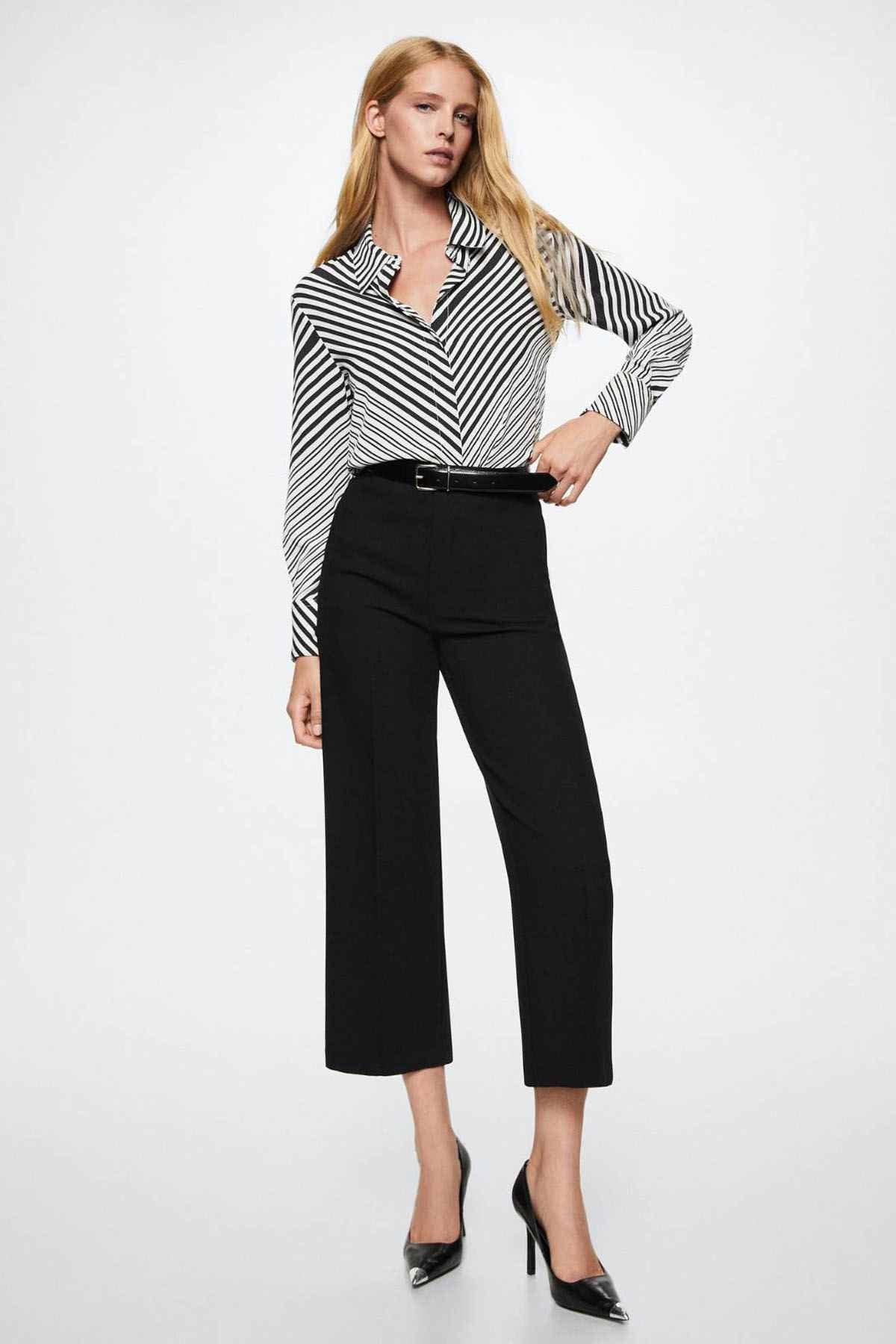 Black-and-white striped blouse with pointed collar, long sleeves, and button placket