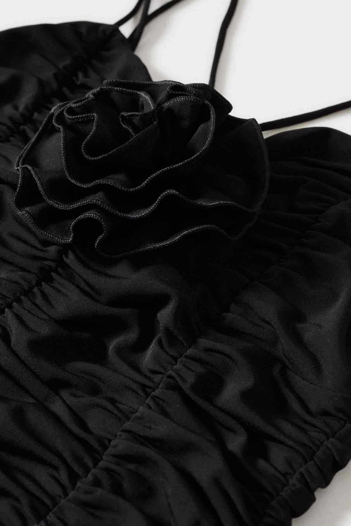 Mango black ruched camisole fabric close-up with layered rosette trim