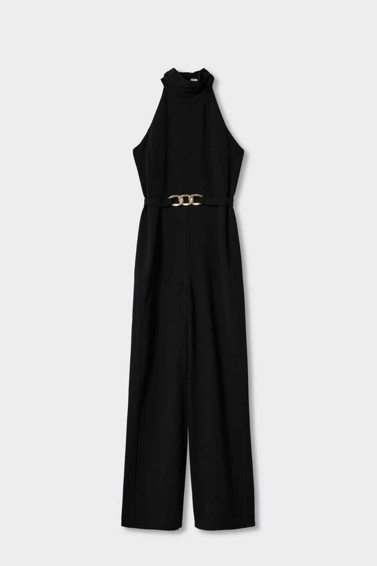 Black sleeveless halter jumpsuit with long neckline tie and gold chain-link belt, wide leg.