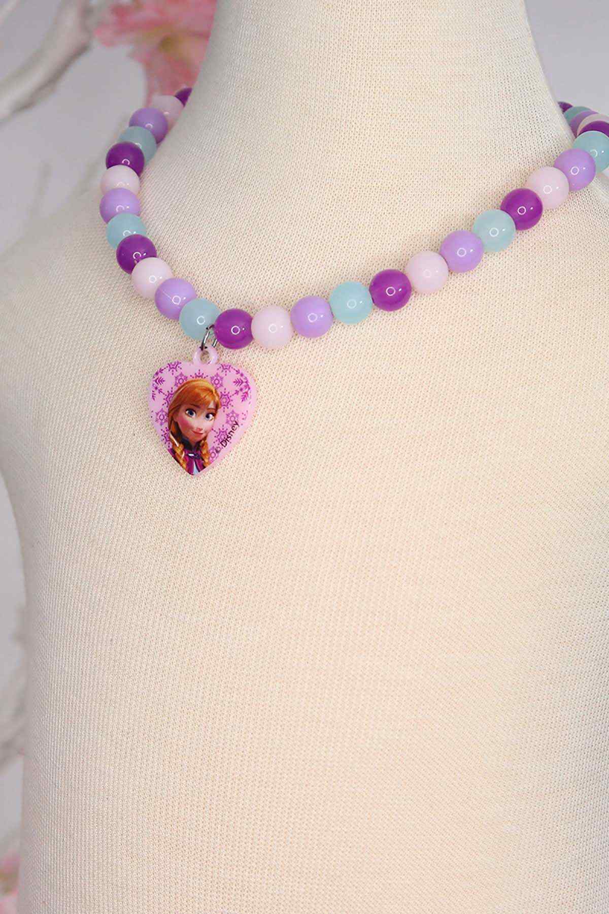 Purple and blue bead necklace with heart pendant on a mannequin