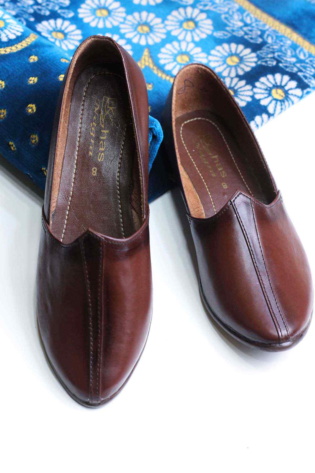 Brown leather loafers, slip-on style with pointed toe and smooth upper