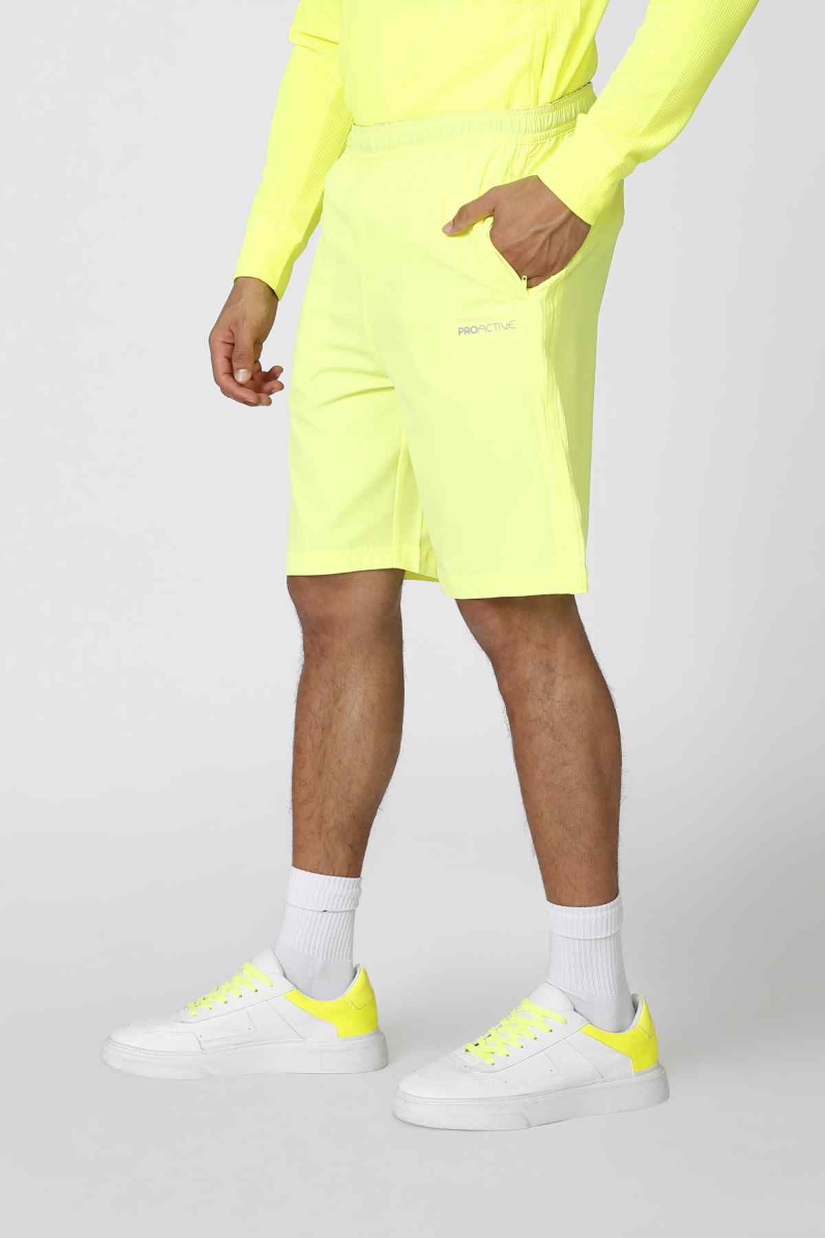 Neon green shorts with elastic drawstring waist and above-knee hem