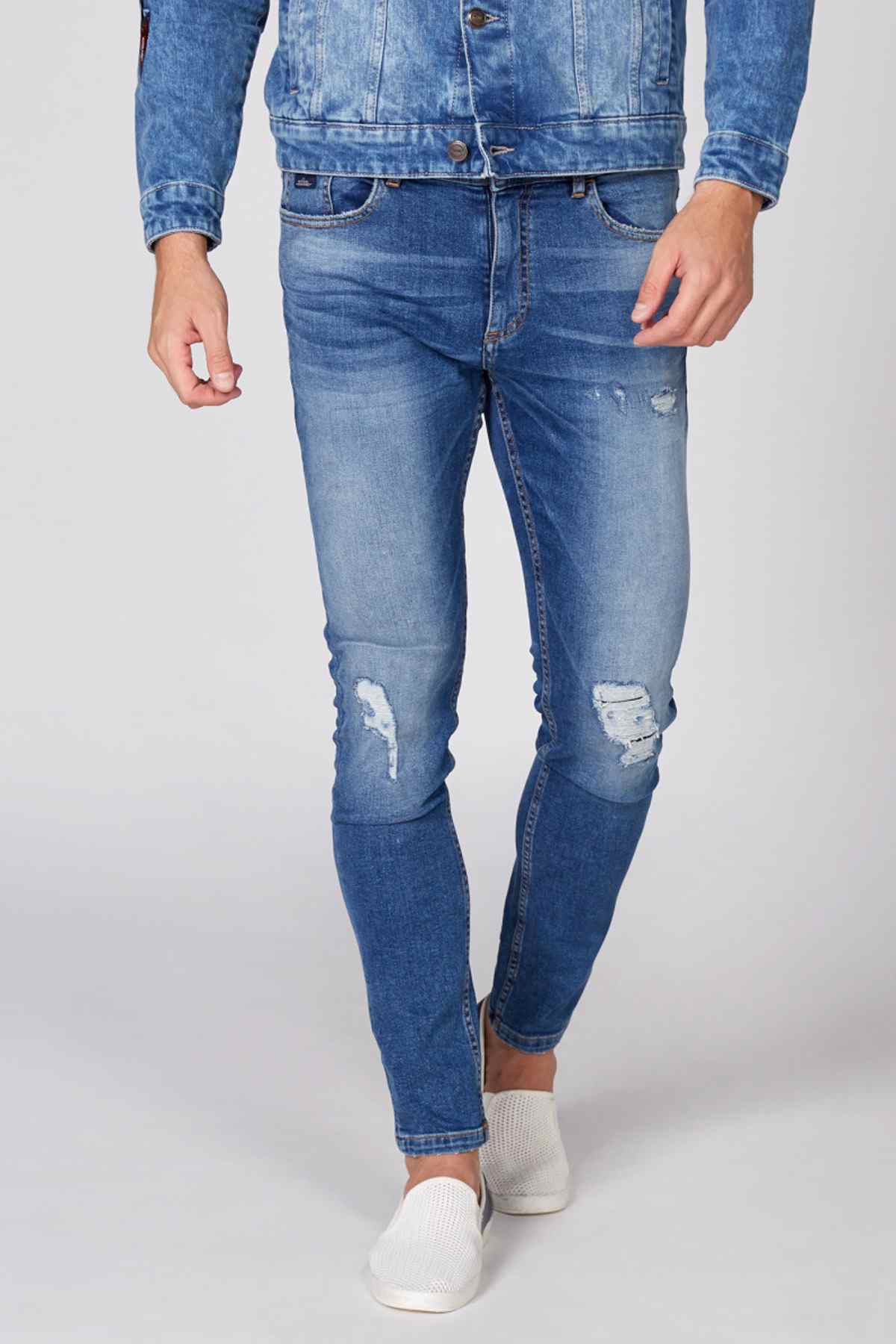 Blue distressed slim jeans with knee and thigh rips and belt loops