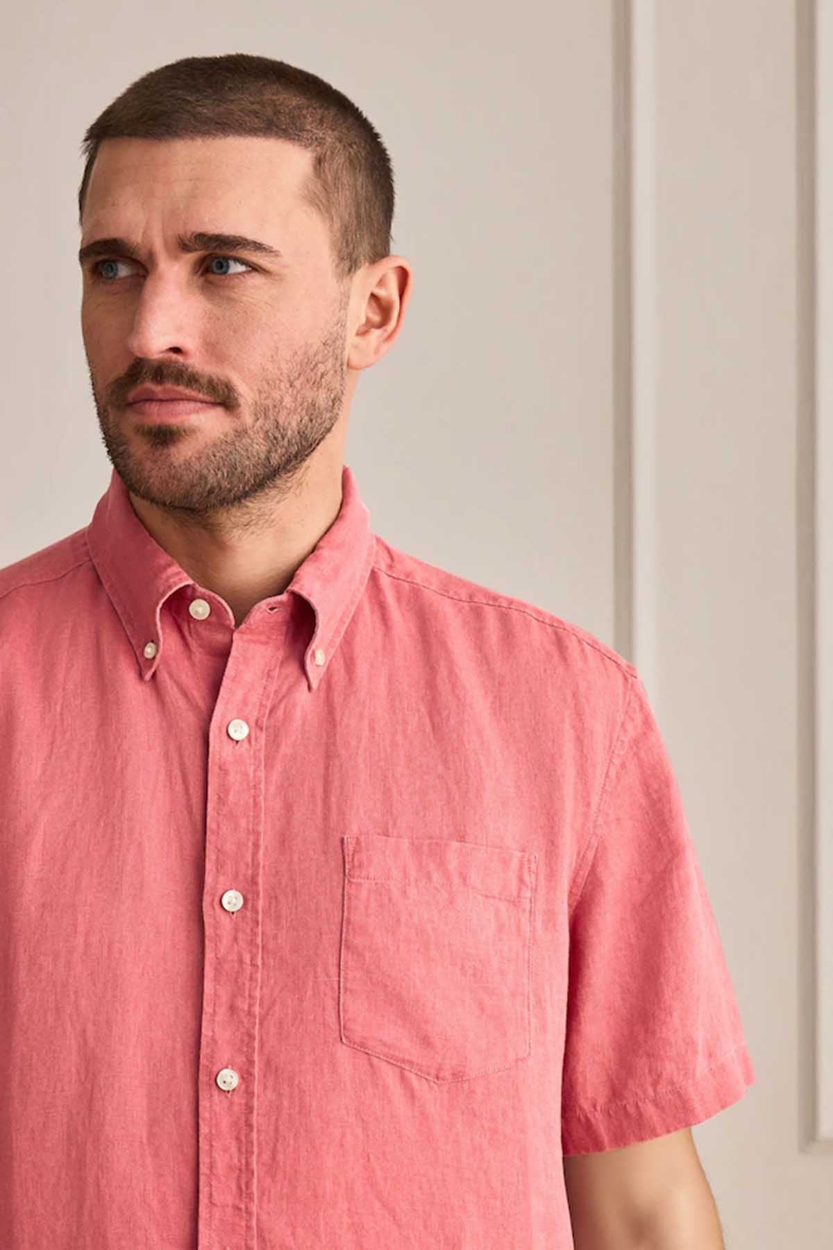 Men's red short-sleeve button-down shirt close-up, chest pocket and button placket
