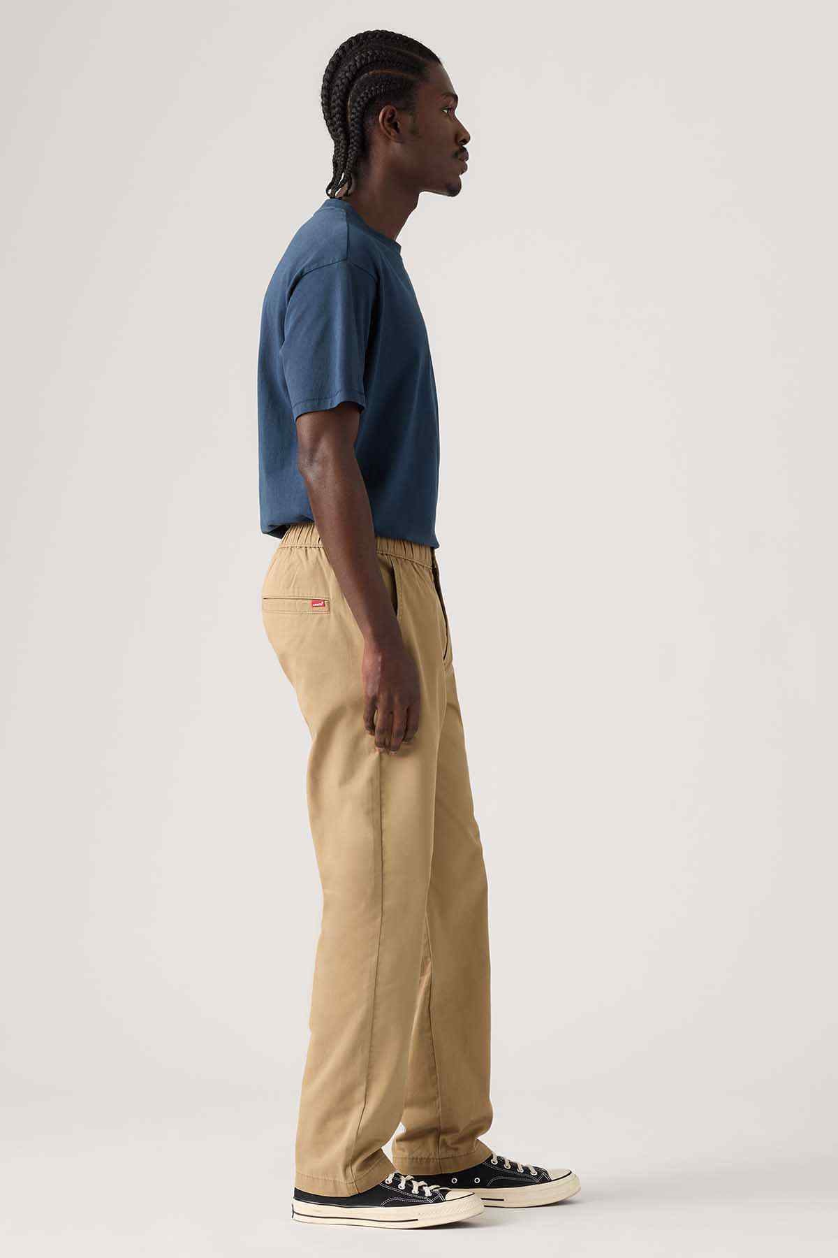 Tan jogger pants in profile with elastic waistband and side pockets