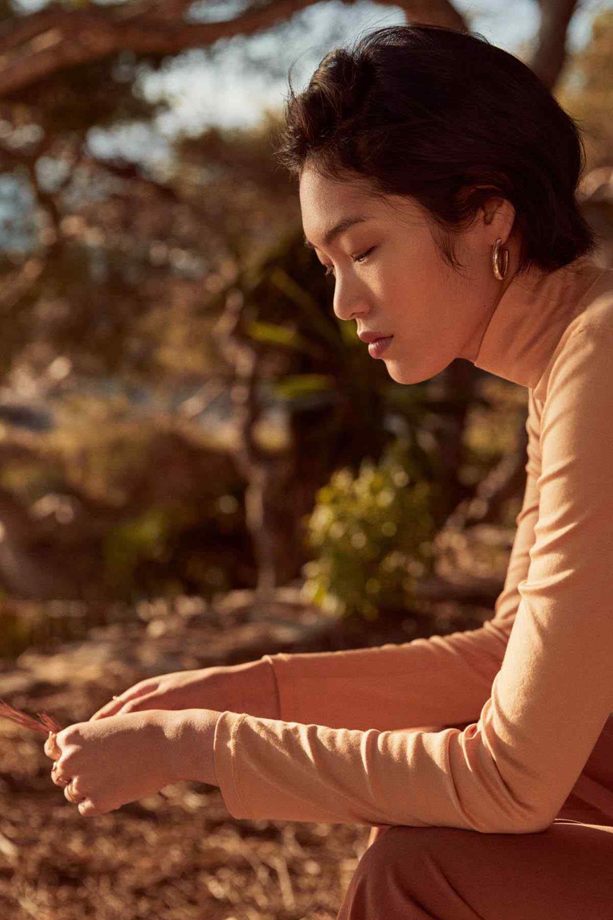 Beige long-sleeve turtleneck top, side view