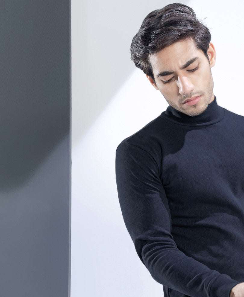Fitted black long-sleeve turtleneck top side view, smooth fabric and slim silhouette