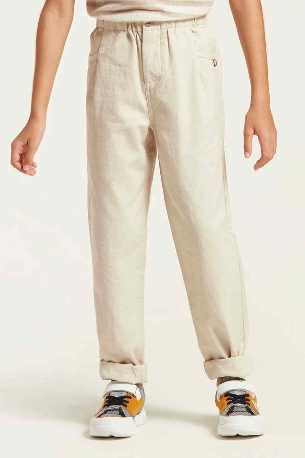 Beige kids' trousers with elastic waistband and cuffed hems