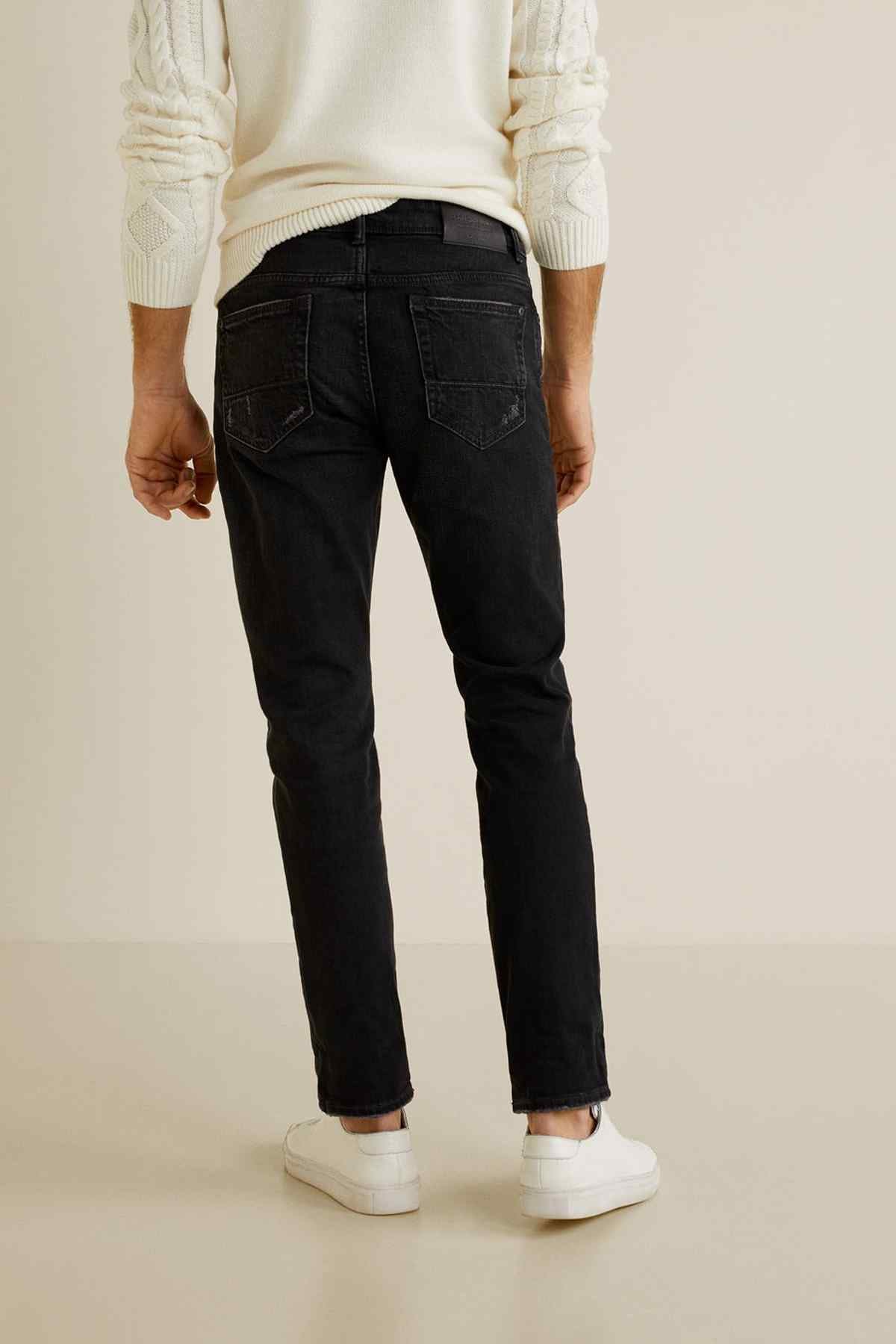 Black denim jeans, zip fly with belt loops and stitched back pockets.