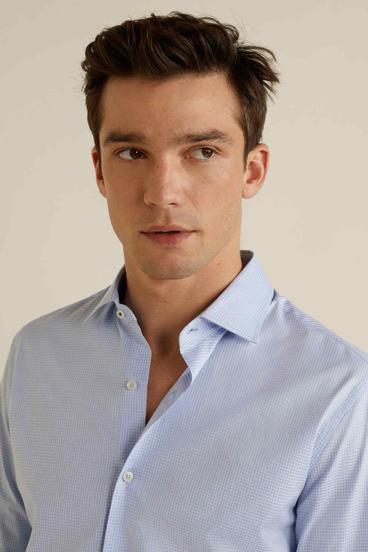 Light blue patterned dress shirt collar with button placket and long sleeves
