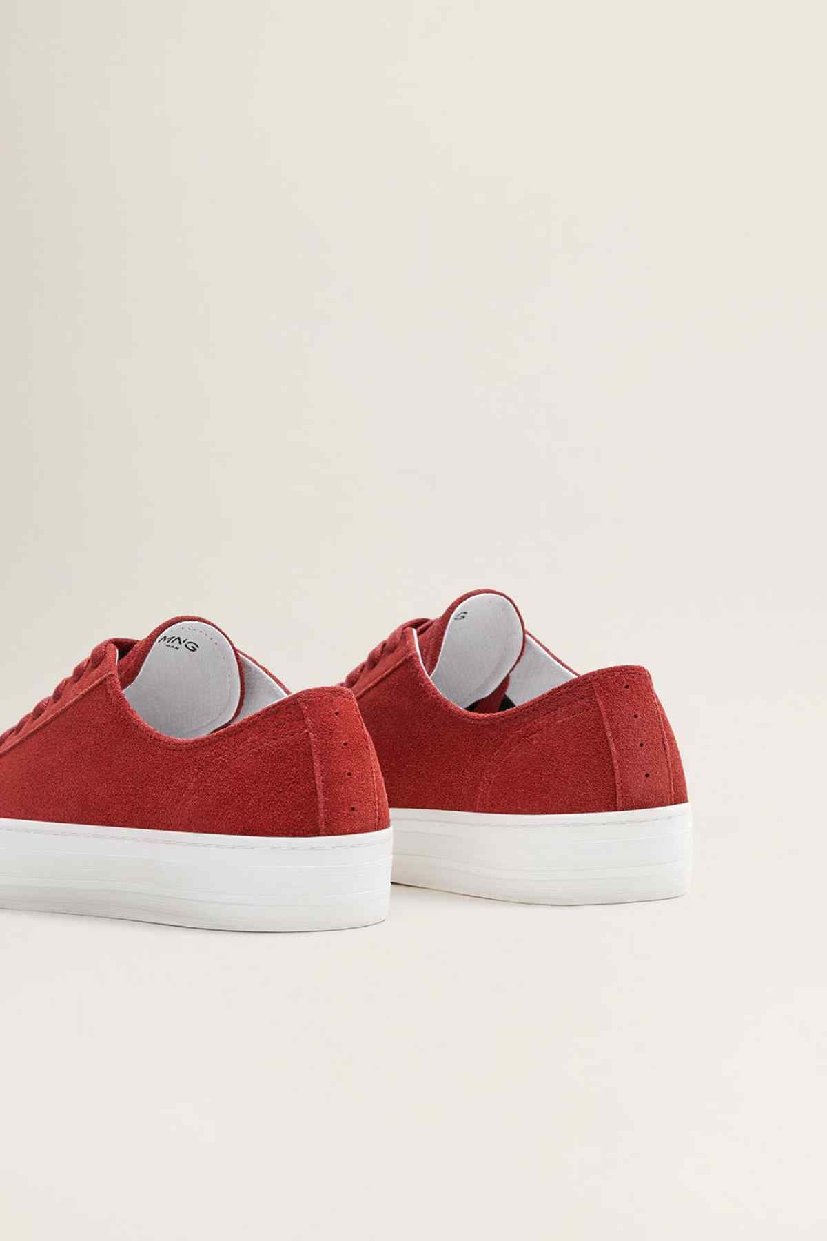 Red low-top sneakers with lace-up front and white rubber heel sole, back view