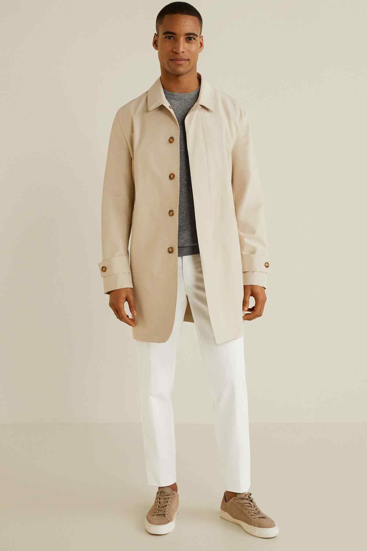Off-white straight-leg pants with front creases and cuffed hem