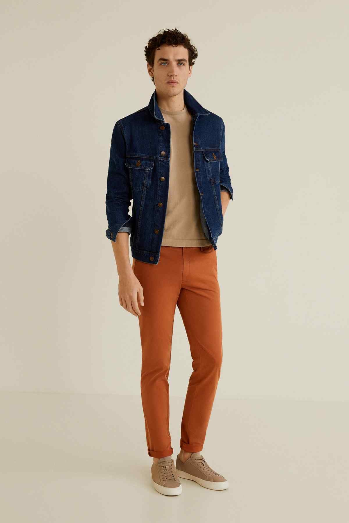 Burnt orange slim ankle pants with button and zip front, cuffed hem