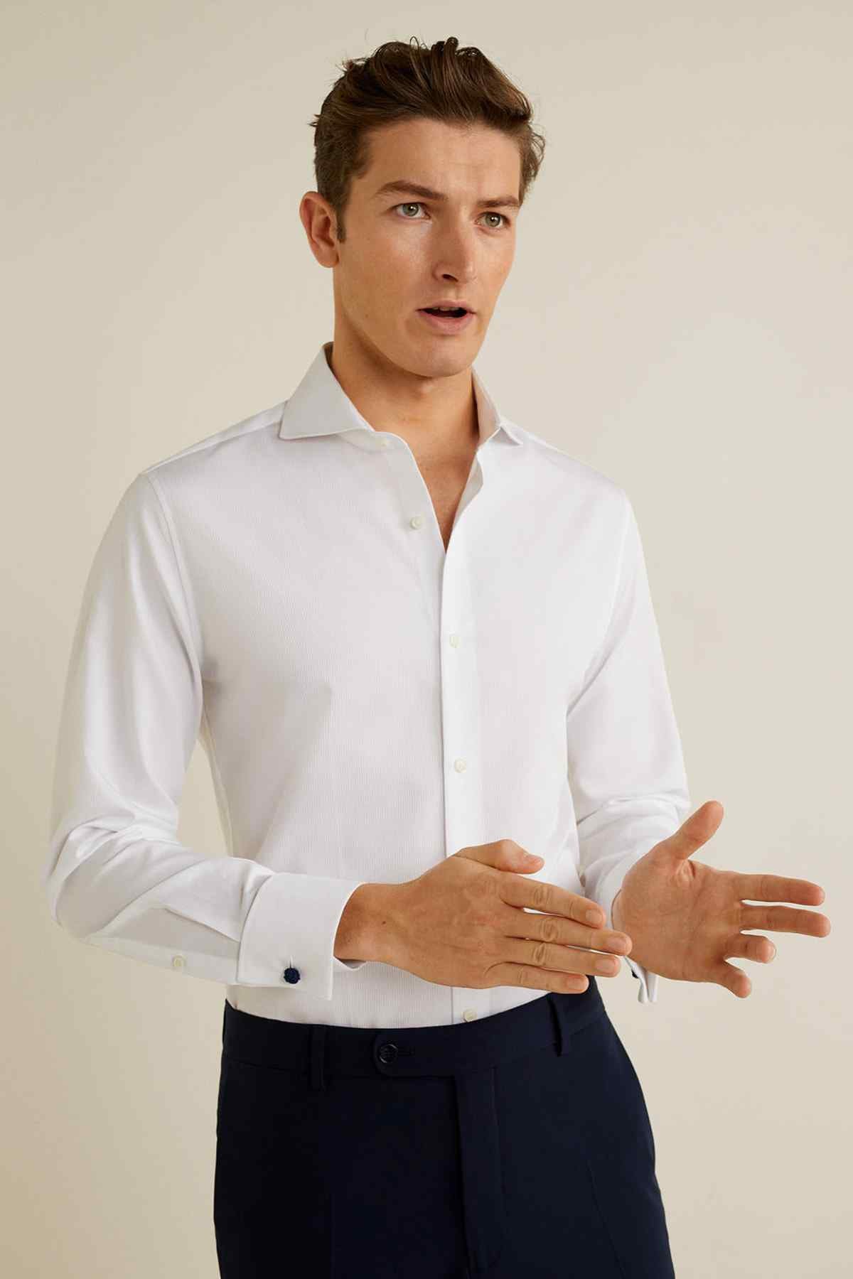 White button-up dress shirt with long sleeves, spread collar, and button cuffs