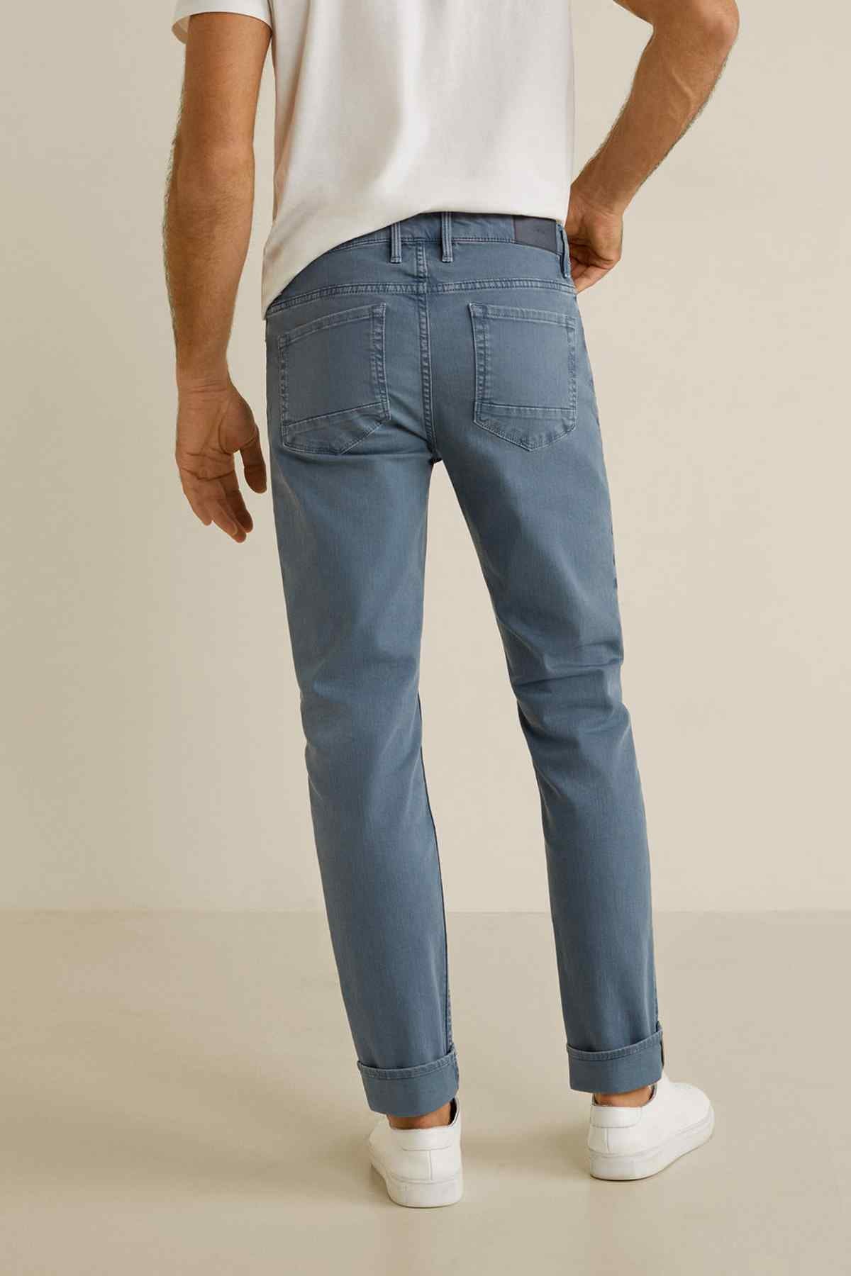 Men's light blue denim jeans with cuffed hems and stitched front pockets