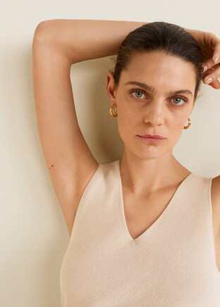 Women’s sleeveless V-neck knit top, close-up on neckline and texture