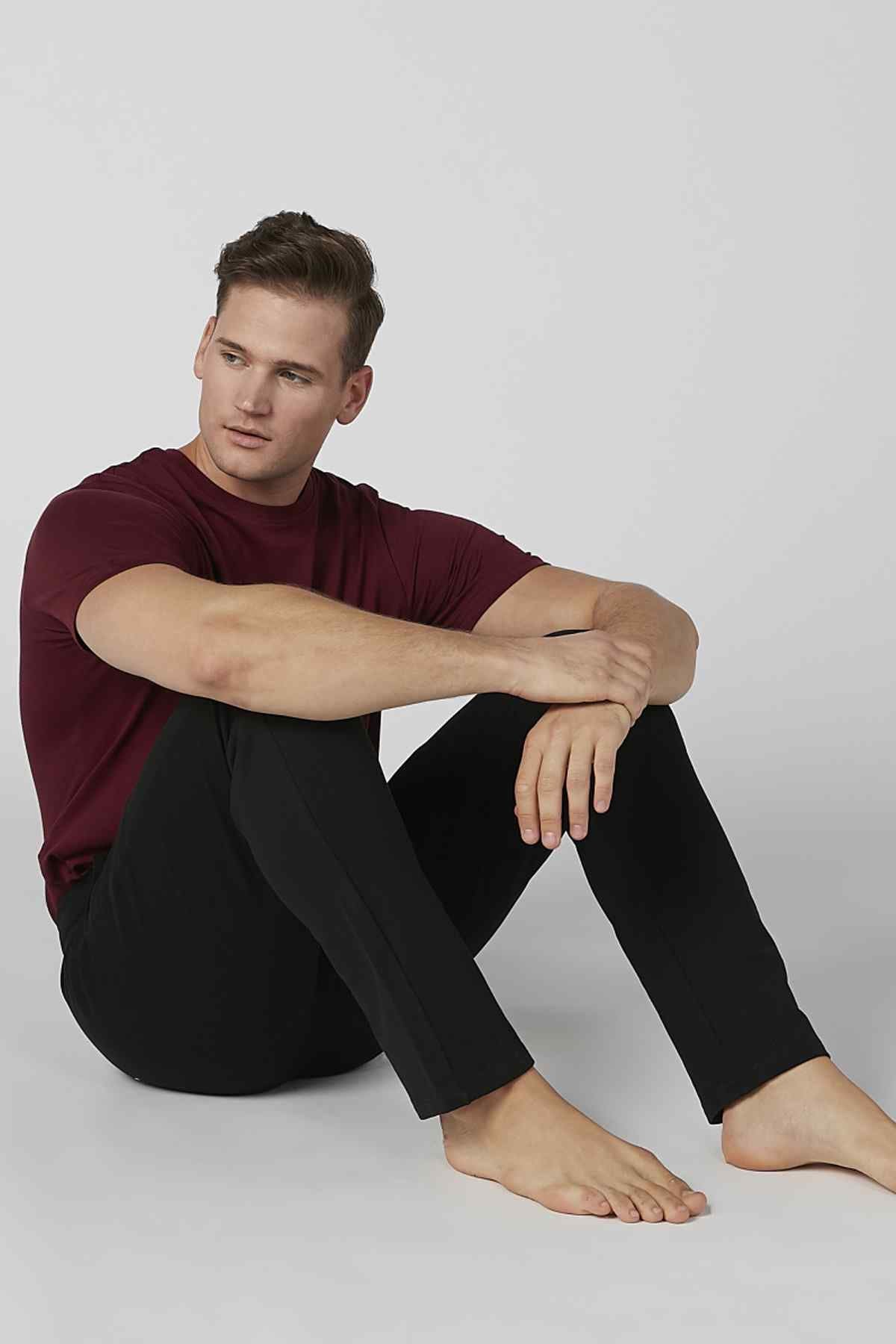 Black jogger pants with drawstring waist, slim tapered legs, ankle cuffs