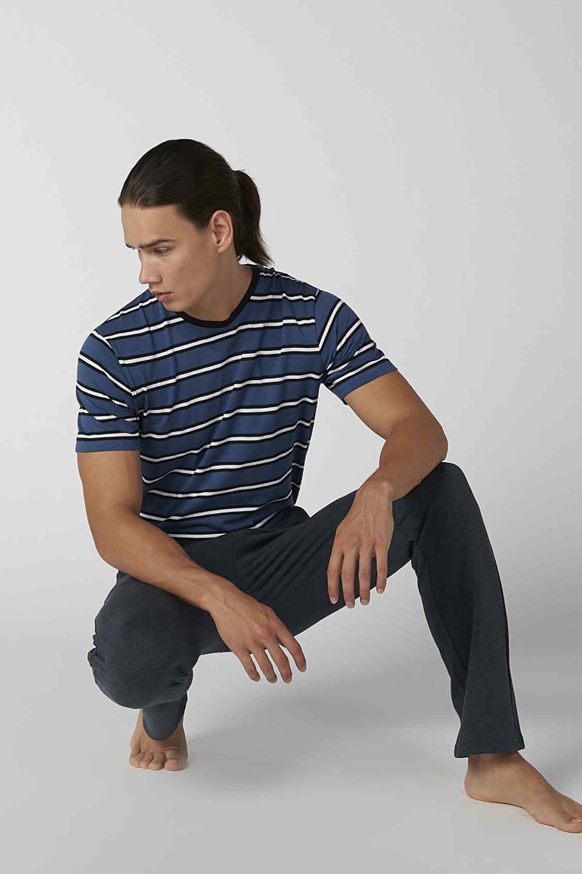 Navy and white striped short-sleeve shirt with dark lounge pants, drawstring waist