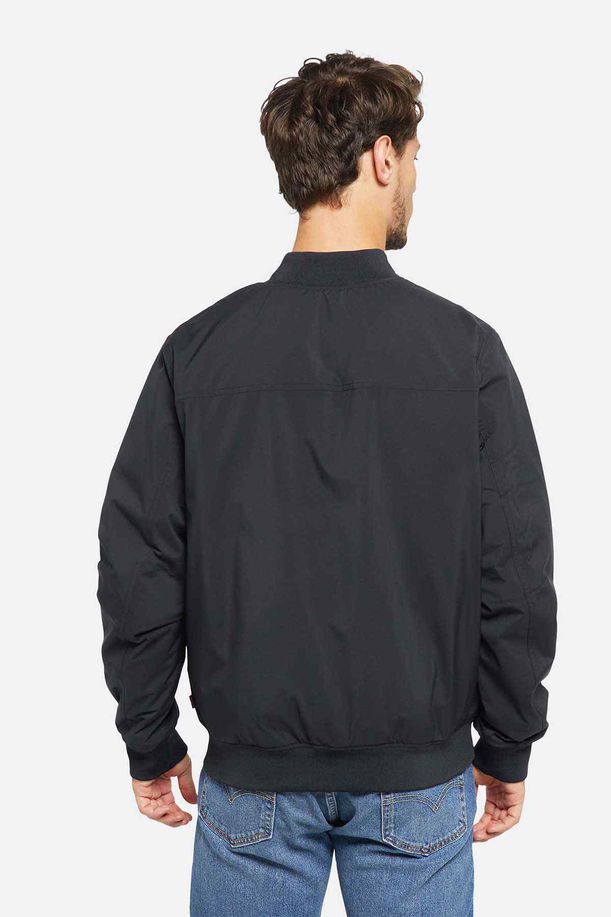 Back view of black bomber jacket with ribbed hem and cuffs