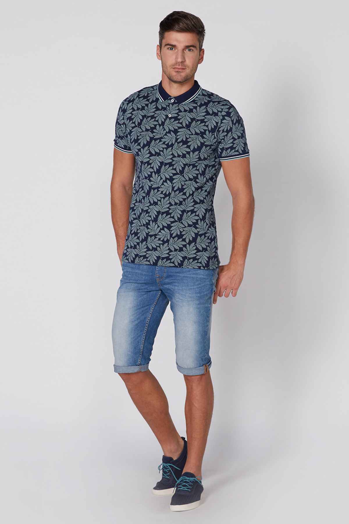 Navy leaf-print polo shirt with short sleeves and striped trim