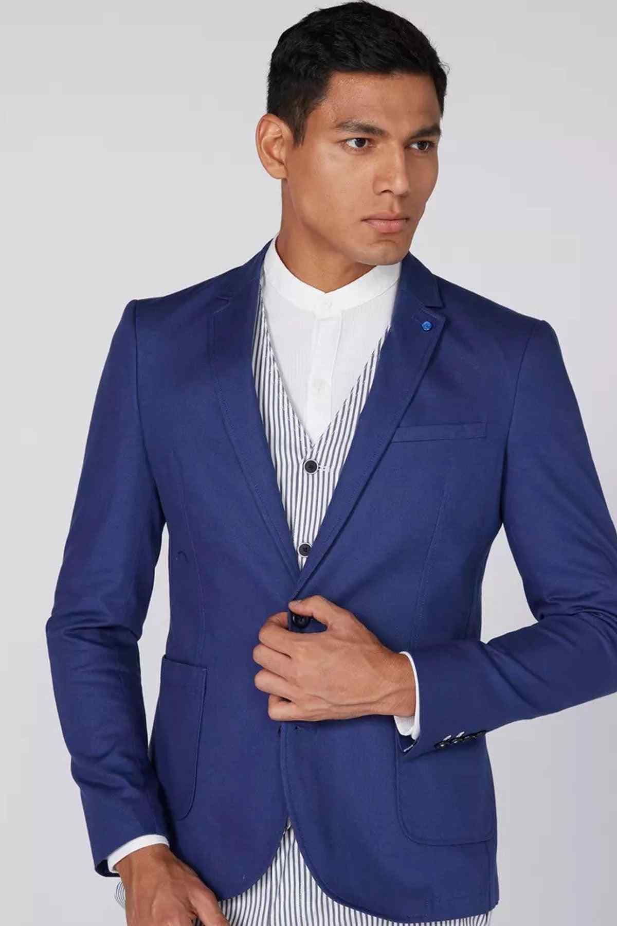 Blue blazer with white shirt and striped vest, three-quarter view