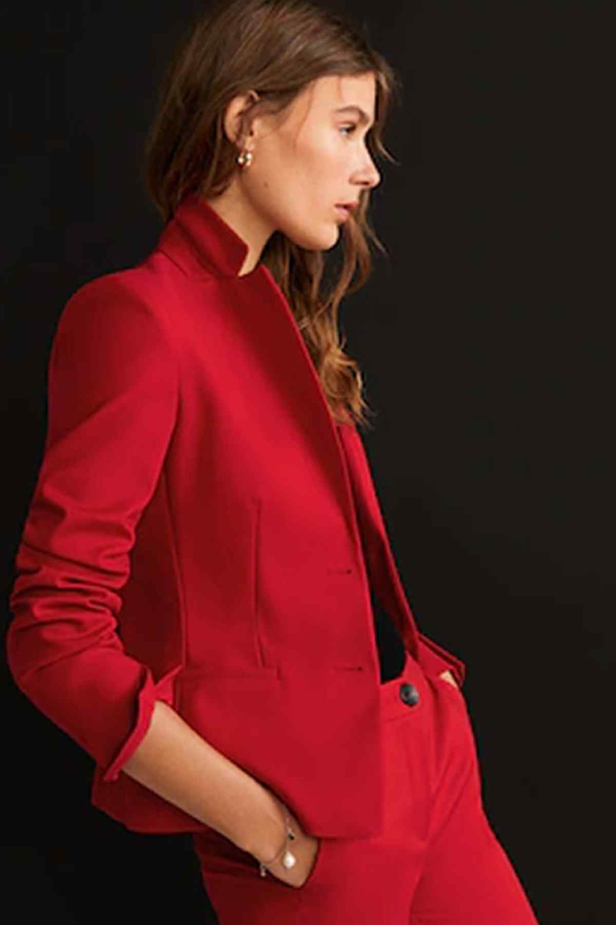Red structured blazer with welt pockets and button cuffs, side view