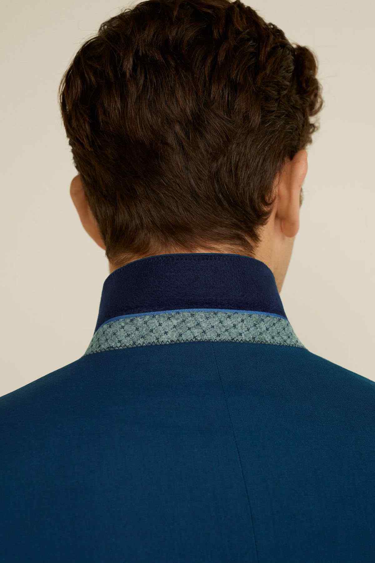 Men's turquoise-blue suit blazer back view with textured inner collar trim