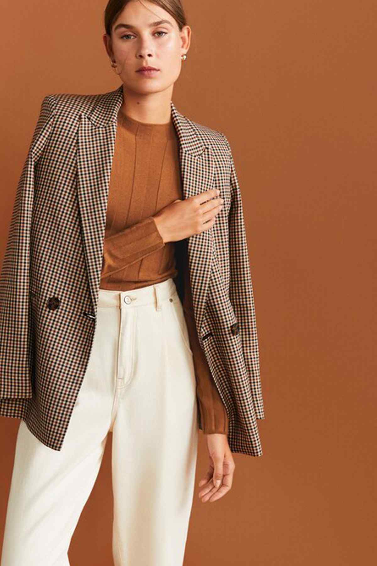 Caramel ribbed knit crew-neck sweater worn under check blazer