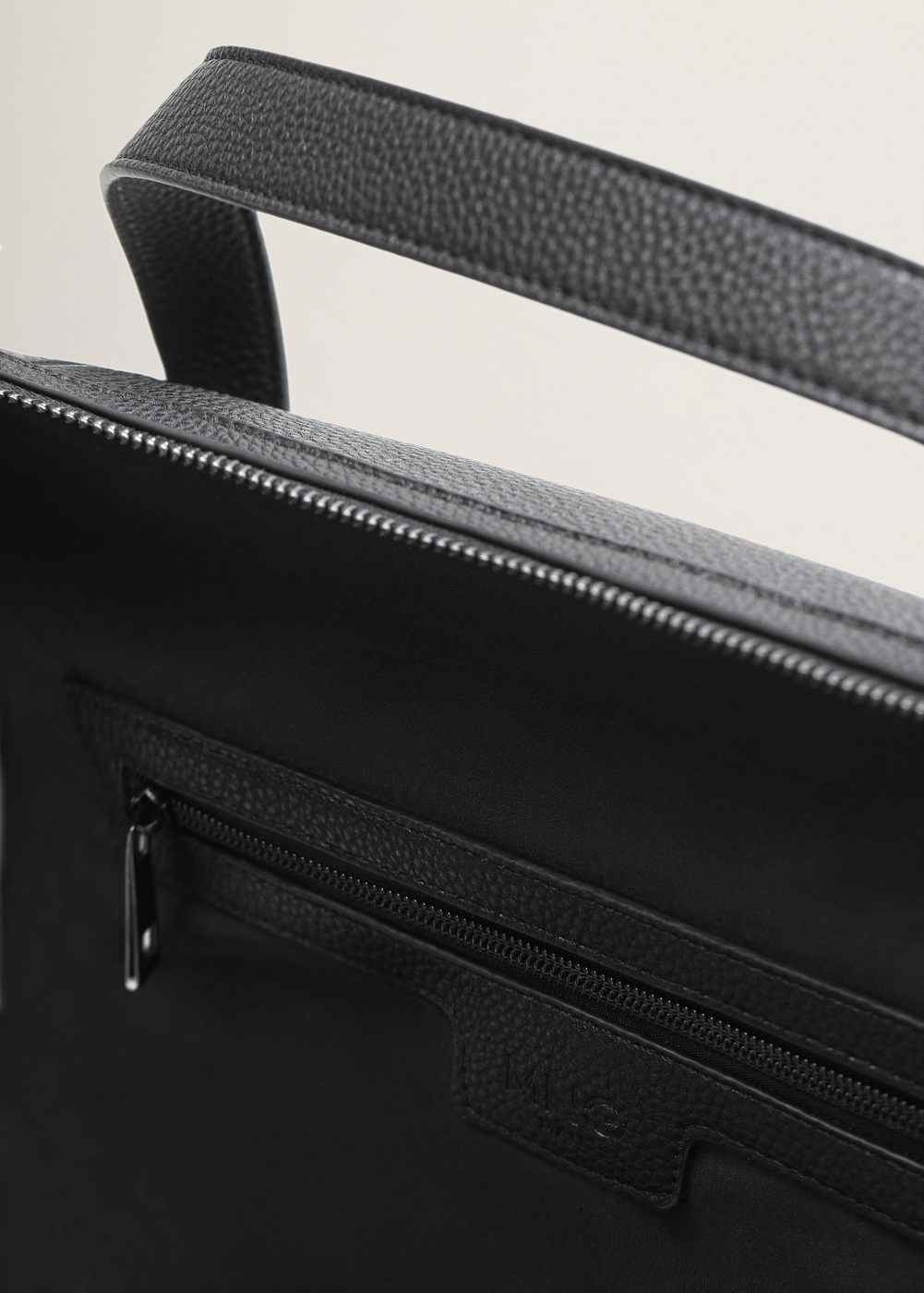 Black duffel bag interior zip and small slip pocket detail