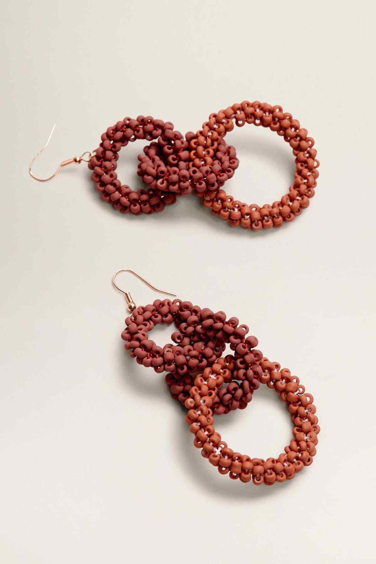 Beaded hoop drop earrings, curled triple loop shape, rust and dark orange beads