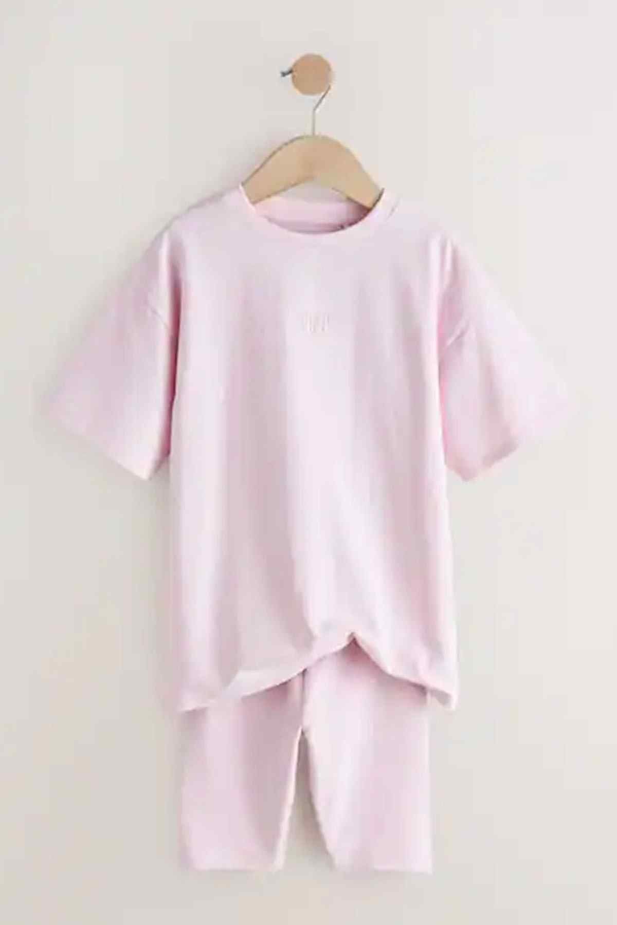 Kids pink T-shirt and cycling shorts set on wooden hanger, crew neck