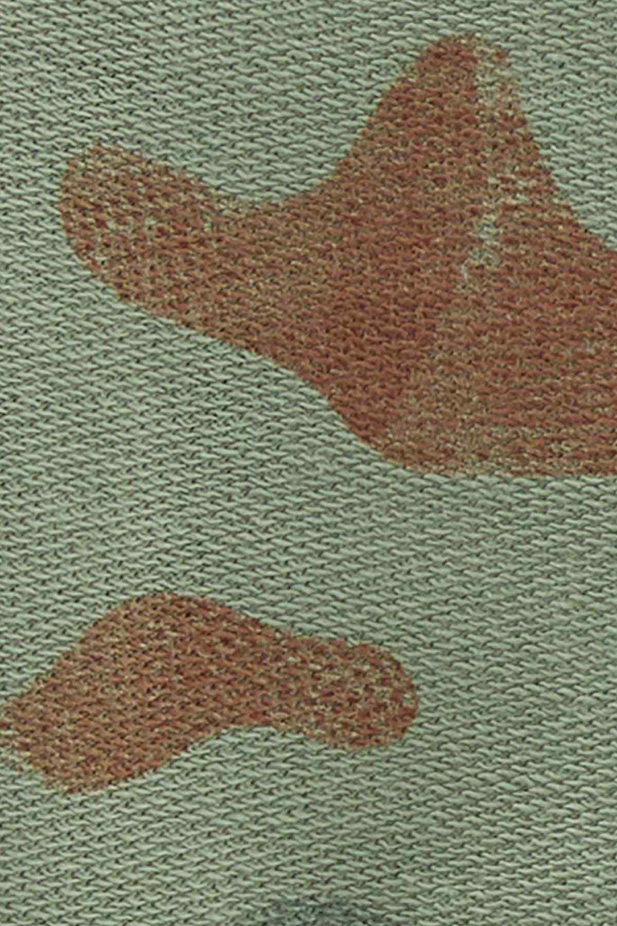 Green knit fabric with brown camouflage pattern