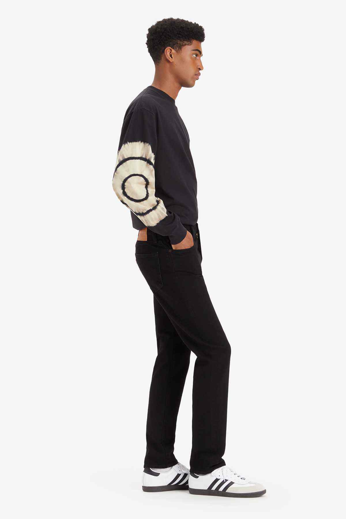 Levi's black straight-leg jeans on model, side view with belt loops