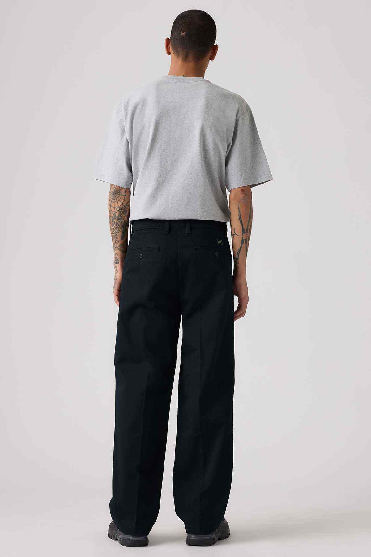 Levi's black wide-leg pants and gray crew-neck T-shirt, back view