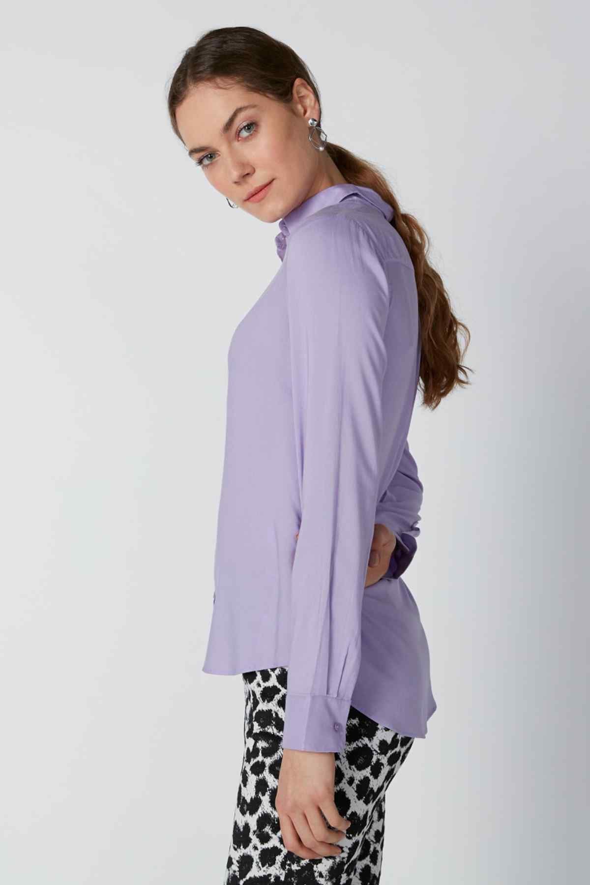 Purple long-sleeve button-up shirt in side profile with pointed collar
