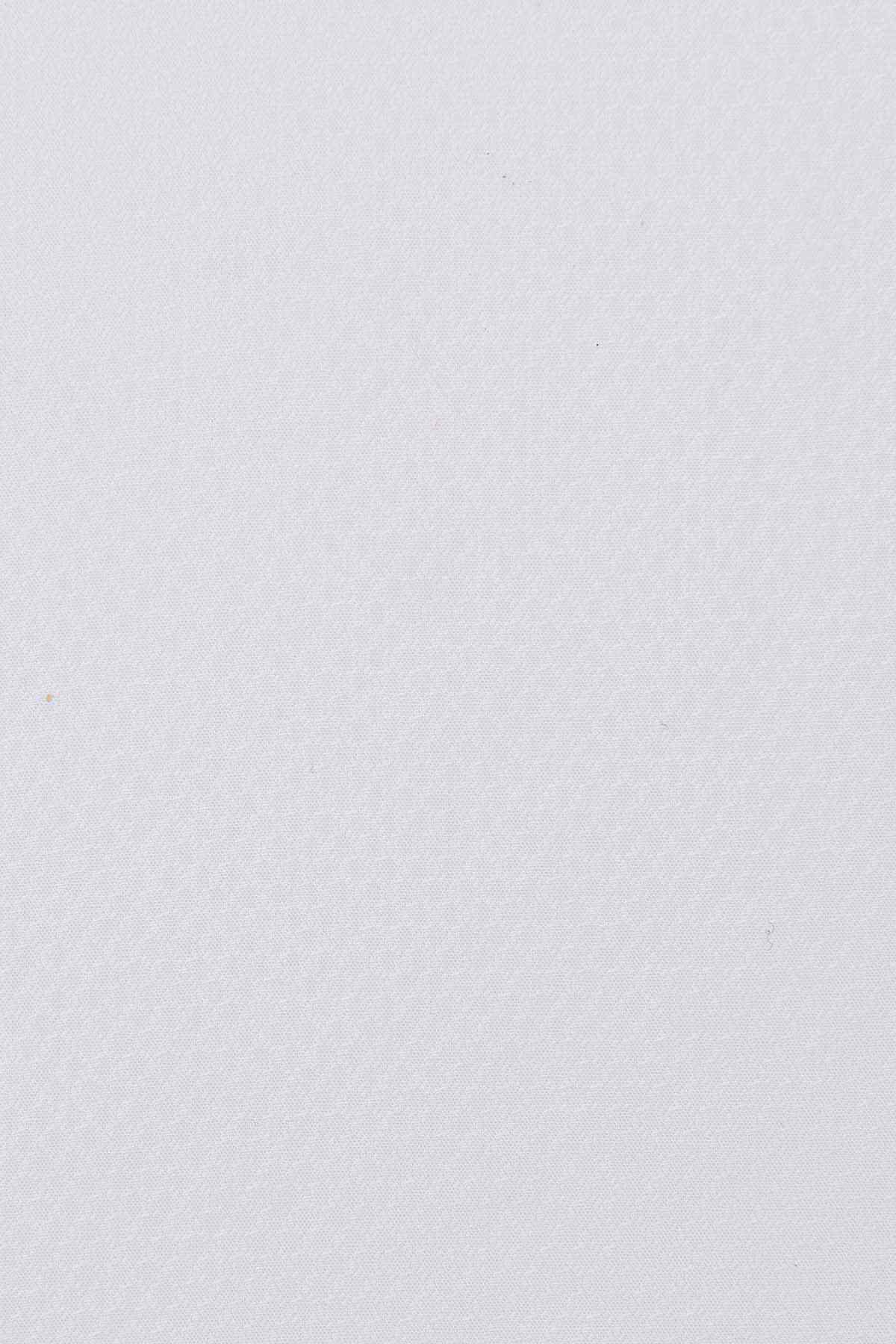 White dress shirt fabric close-up with subtle textured weave