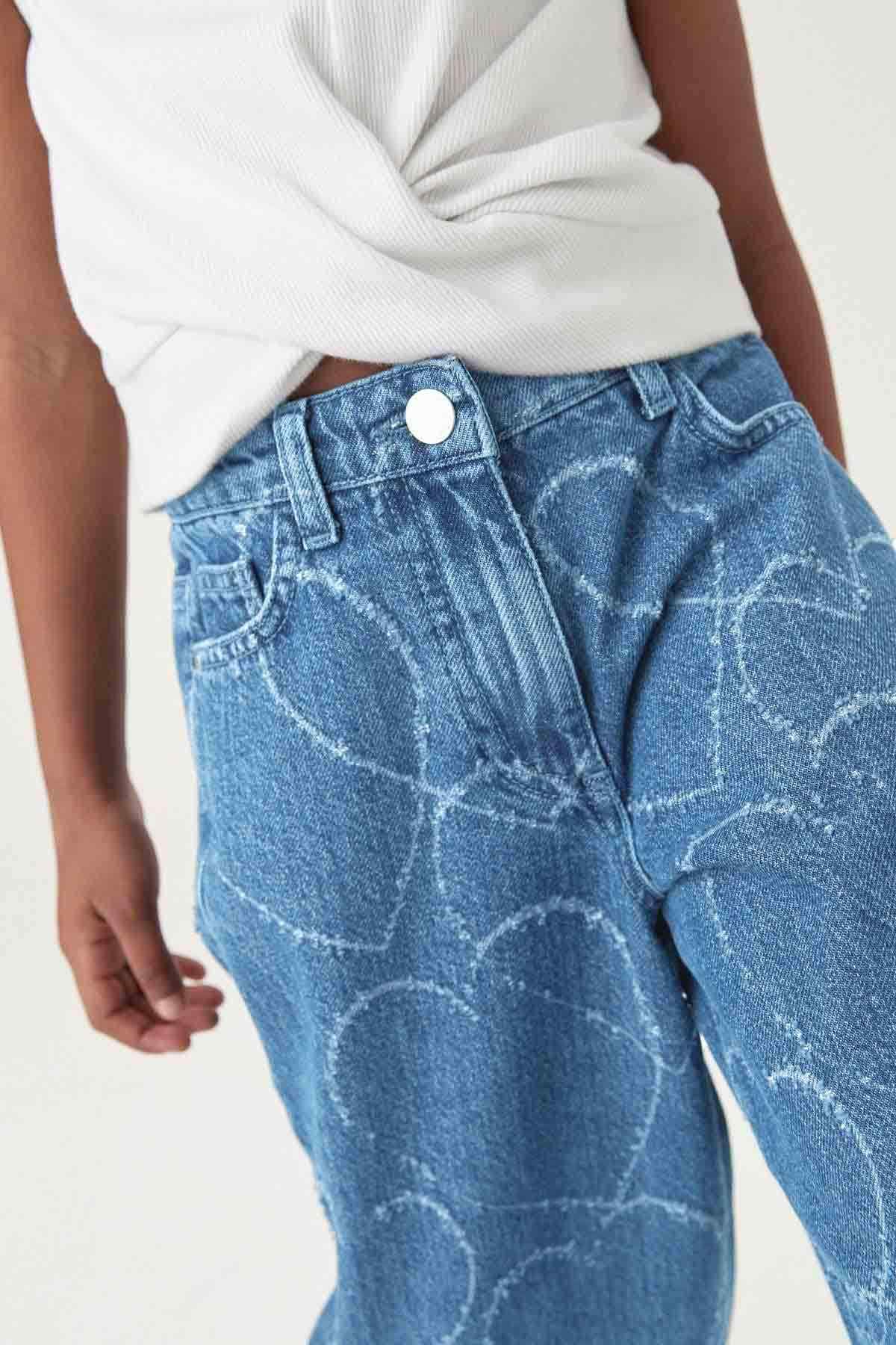 NEXT mid blue denim jeans close-up, button waistband and allover cloud pattern