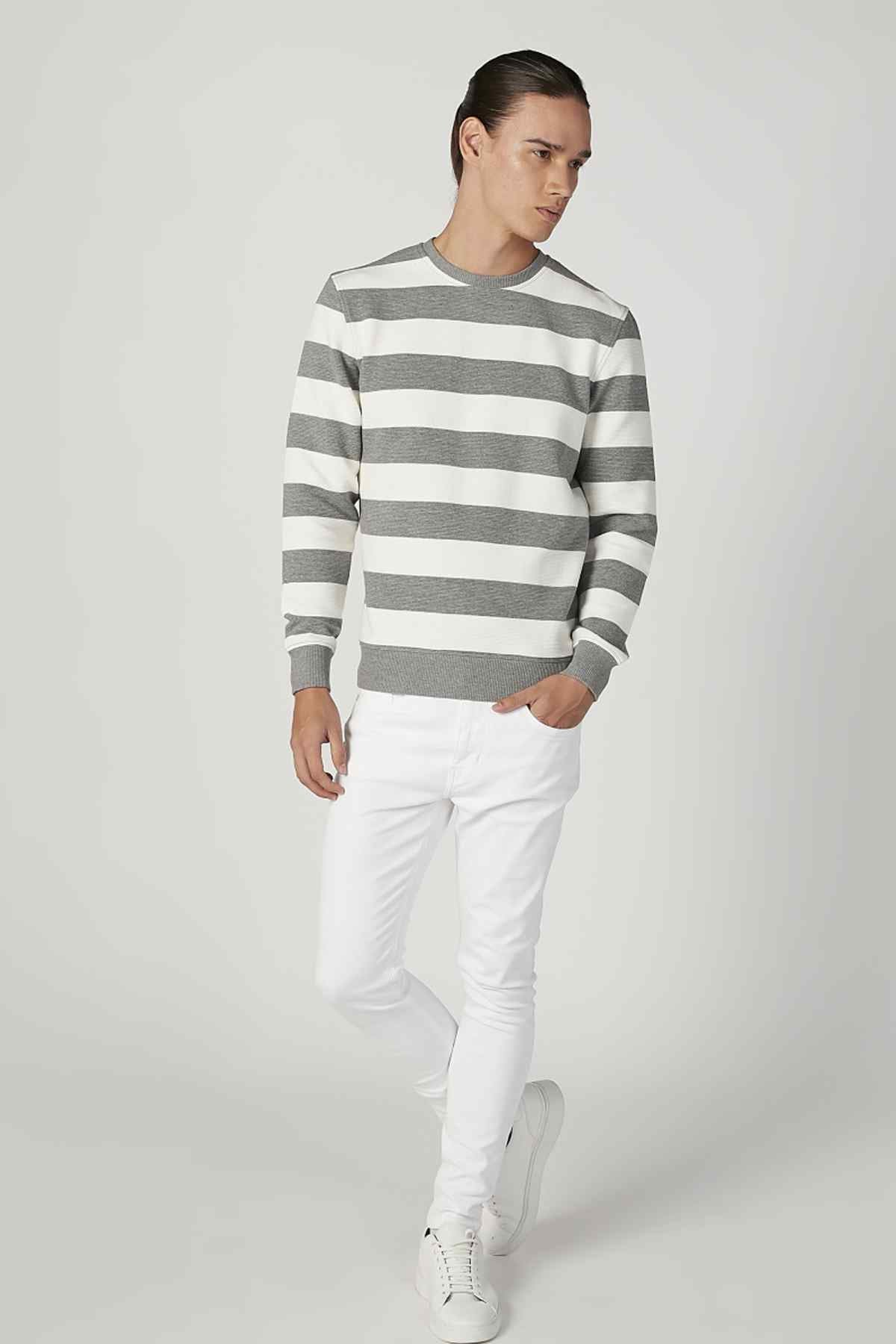 Grey and white striped crewneck sweater in side view