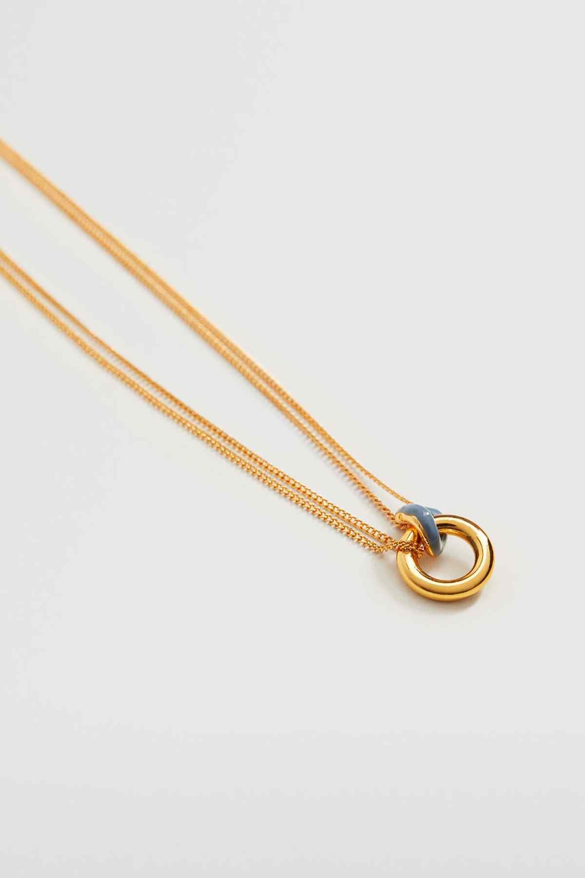Gold-tone chain necklace with blue stone in a round ring pendant detail