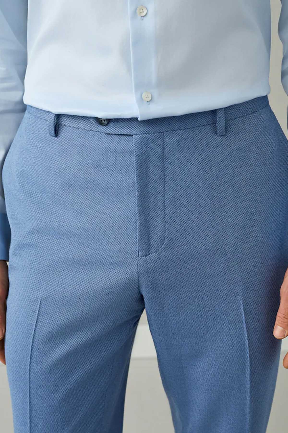 Men's chambray blue suit trousers close-up of waistband with belt loops