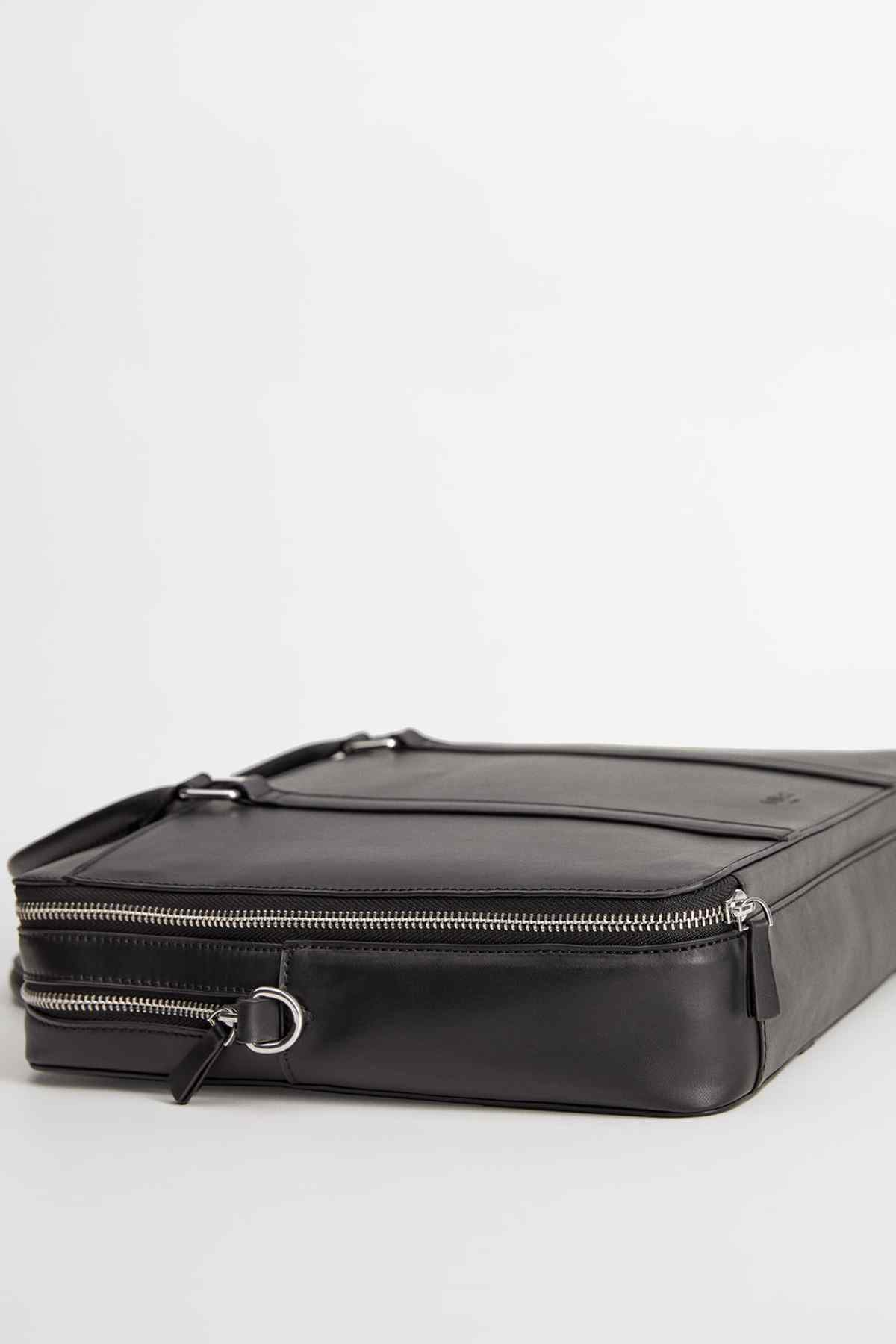 Black zippered bag with adjustable shoulder strap and front zipper pocket