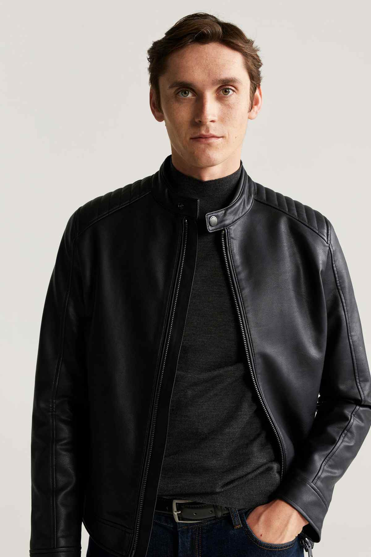 Black leather jacket front view with zip closure and snap collar tab.