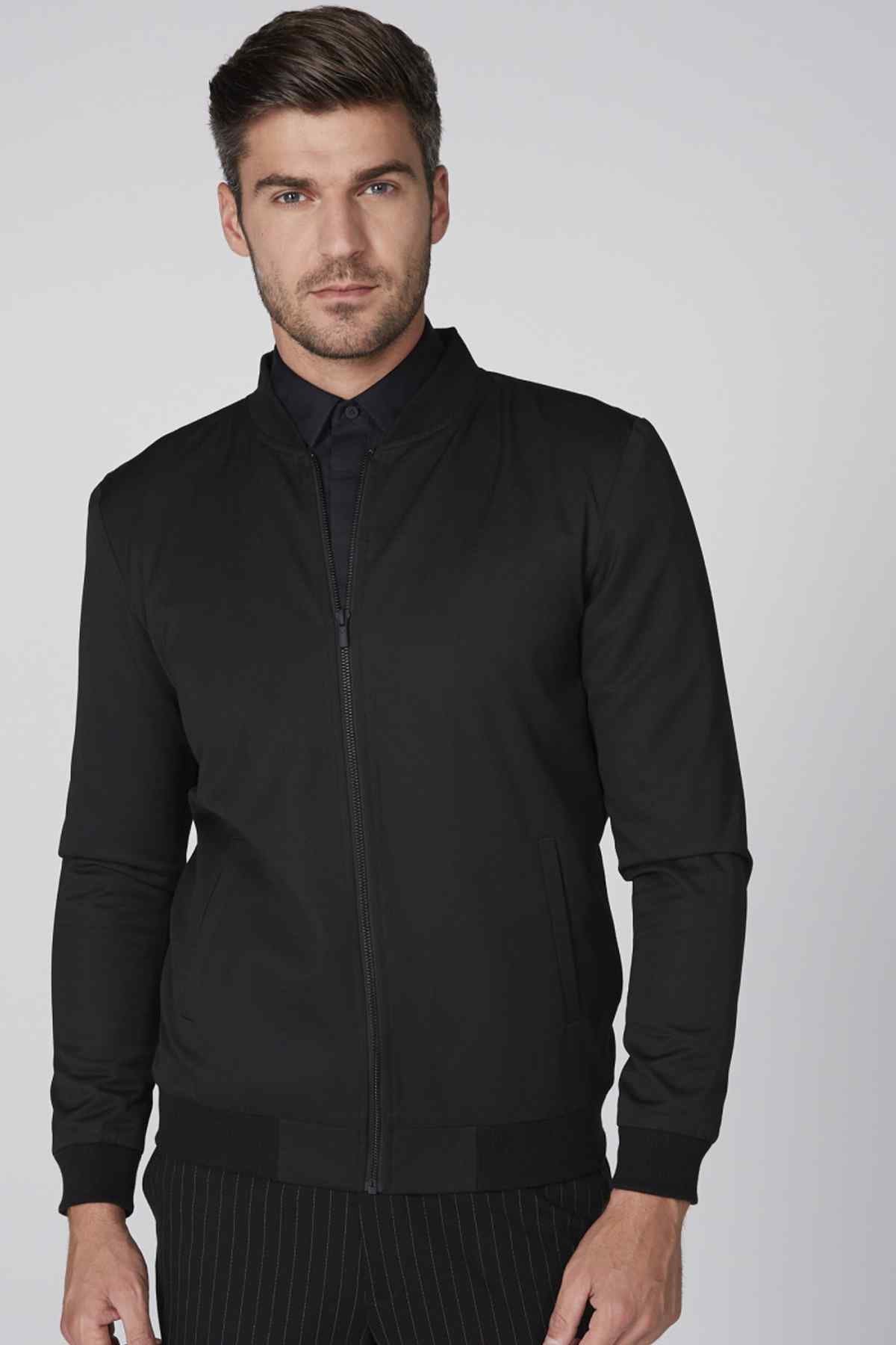 Black zip-up jacket with stand collar and ribbed cuffs