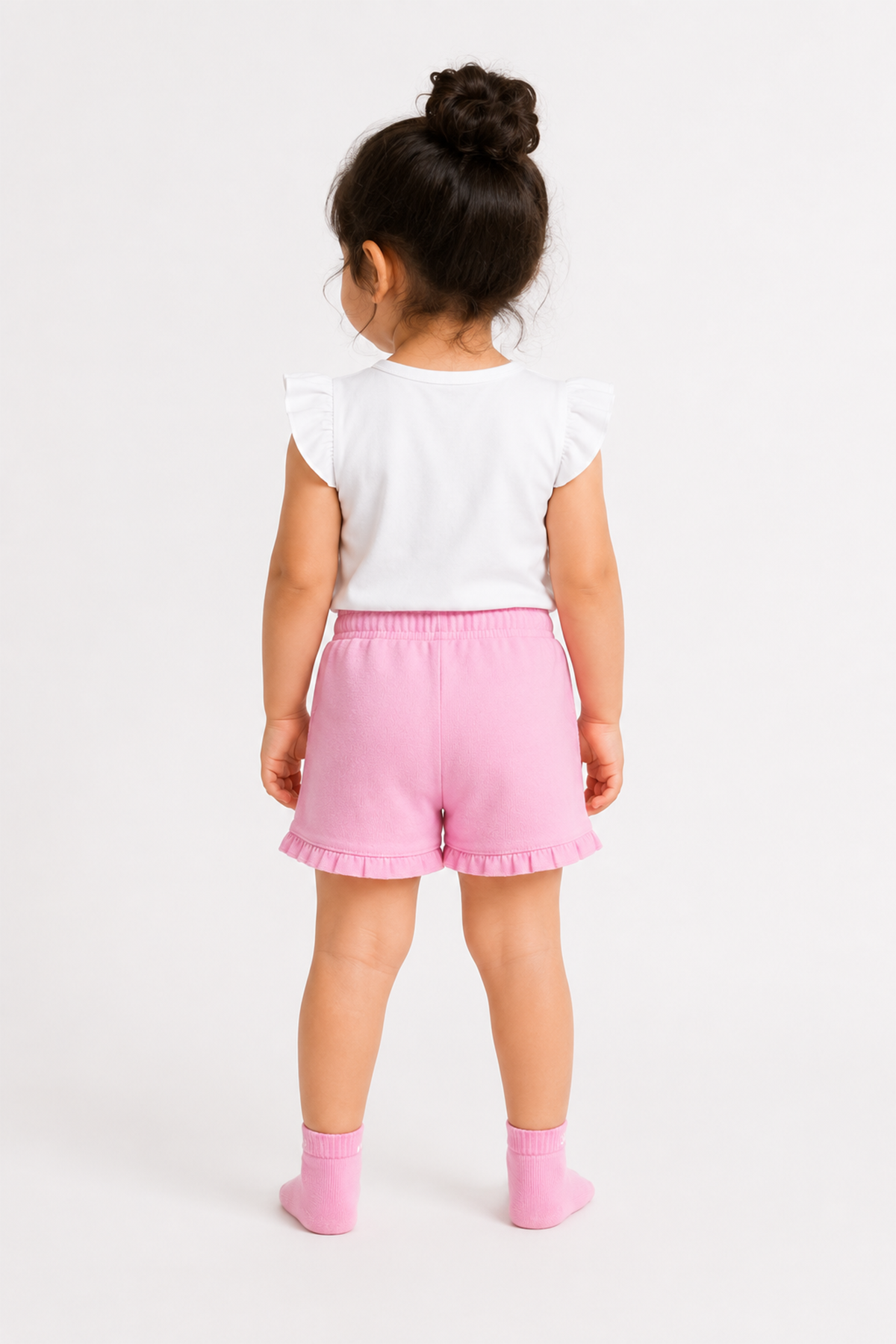 Pink baby shorts with drawstring and ruffle trim, paired with pink socks