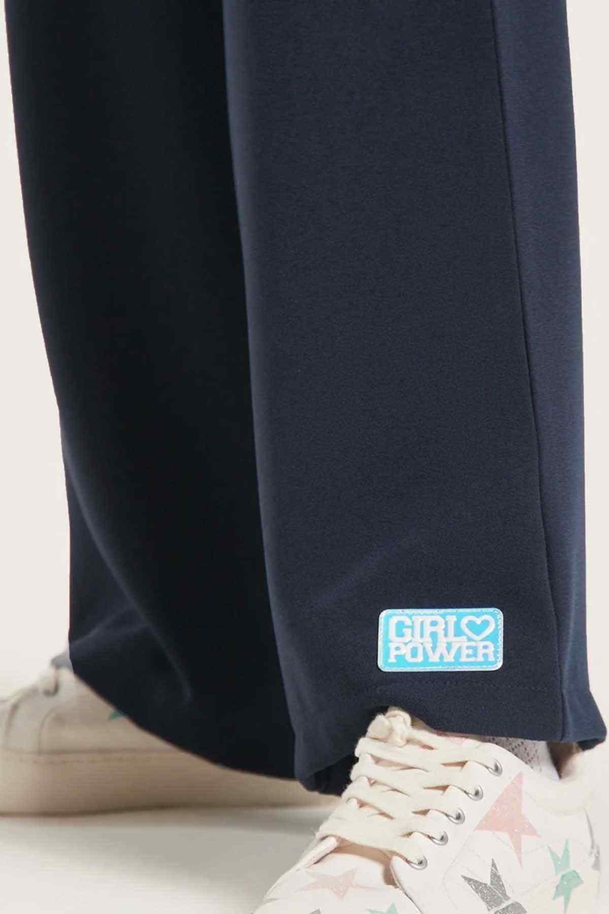 Navy sweatpants with blue 'Cool Power' logo patch at hem